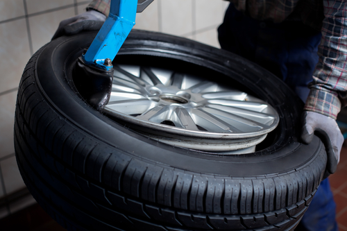 Mechanic changing  car tire closeup