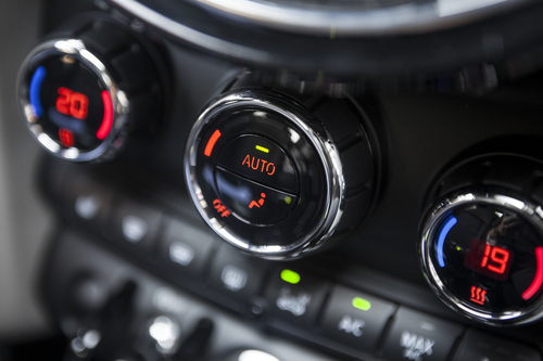 Color detail with the air conditioning button inside a car.